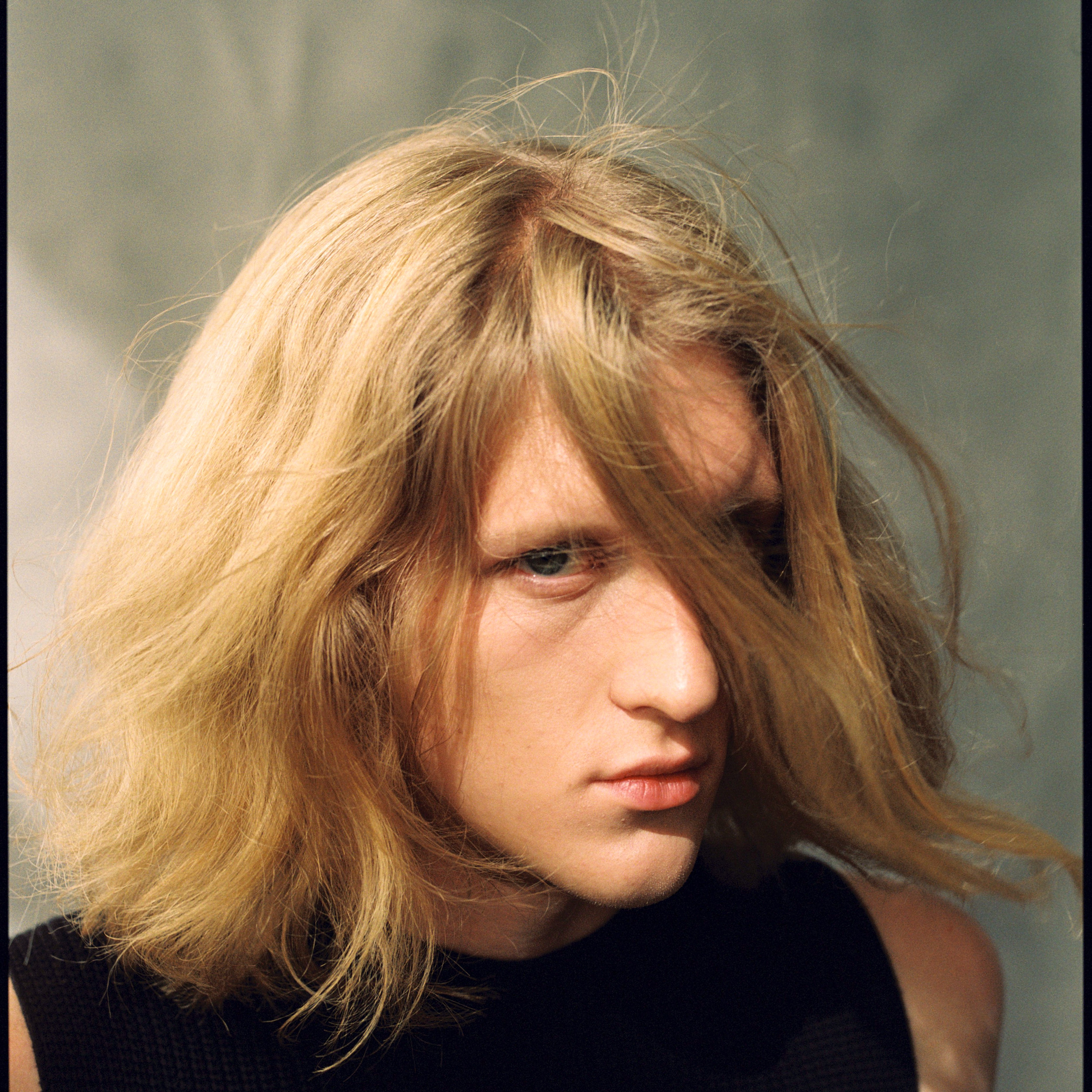 Portrait of a young blond man with the long hair